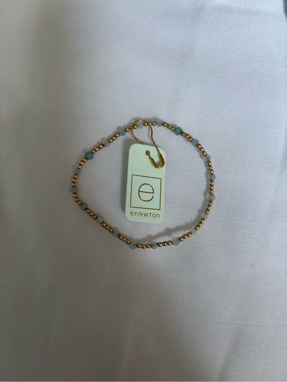 eNewton Gold with grey and teal gemstones